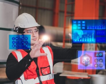 Asian Engineer using technology visual screen and working in factory technology software for future